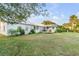 Expansive backyard featuring a wooden deck, lush lawn, and mature trees for privacy and shade at 561 Seaward Dr, Charleston, SC 29412