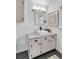 Bathroom featuring a vanity with a white marble countertop, hexagon tile floor, and an art print on the wall at 561 Seaward Dr, Charleston, SC 29412