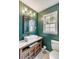 Charming powder room with marble countertop, wood cabinets and a window at 561 Seaward Dr, Charleston, SC 29412
