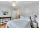 Stylish bedroom with decorative headboard, round mirror, and bedside table at 561 Seaward Dr, Charleston, SC 29412