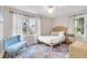 Cozy bedroom with a bed, colorful rug, and natural light from the windows at 561 Seaward Dr, Charleston, SC 29412