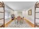 Dining room with hardwood floors, decorative rug, large window, and decorative wood shelving at 561 Seaward Dr, Charleston, SC 29412