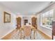 Dining room with hardwood floors, decorative rug, large window, and decorative wood shelving at 561 Seaward Dr, Charleston, SC 29412