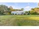 A view of the white brick home and spacious backyard, perfect for outdoor activities and relaxation at 561 Seaward Dr, Charleston, SC 29412