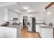 Spacious kitchen featuring stainless steel refrigerator, white cabinets, granite countertops, and light wood flooring at 561 Seaward Dr, Charleston, SC 29412