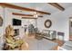 Stylish living room with fireplace, wood beams, and open concept design, flowing into the modern kitchen at 561 Seaward Dr, Charleston, SC 29412