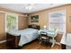 Cozy bedroom with hardwood floors, two windows, and blue accent desk at 5907 Murray Dr, Hanahan, SC 29410