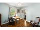 Charming bedroom with hardwood floors, features a desk by the window and a mirrored closet at 5907 Murray Dr, Hanahan, SC 29410
