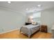 Simple bedroom with a cozy bed, warm lighting, and hardwood-style flooring at 5907 Murray Dr, Hanahan, SC 29410