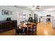 Cozy dining area with wood table, ceiling fan, and bright, adjacent kitchen at 5907 Murray Dr, Hanahan, SC 29410
