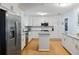 Bright kitchen with white cabinets, stainless steel appliances, and a center island at 5907 Murray Dr, Hanahan, SC 29410