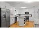 Bright kitchen with white cabinets, stainless steel appliances, and a center island at 5907 Murray Dr, Hanahan, SC 29410