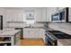 Modern kitchen featuring stainless steel appliances, gray countertops, and white cabinetry at 5907 Murray Dr, Hanahan, SC 29410
