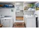 Laundry room with appliances, shelves and an entrance to the kitchen at 5907 Murray Dr, Hanahan, SC 29410