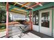 Outdoor patio with colorful beams, keyboard on stand, and screened-in porch entrance at 5907 Murray Dr, Hanahan, SC 29410