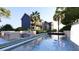 Backyard oasis featuring modern pool, lounge seating, and lush tropical landscaping at 66 Warren St # Main House Only, Charleston, SC 29403