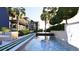 Backyard oasis featuring modern pool, lounge seating, and lush tropical landscaping at 66 Warren St # Main House Only, Charleston, SC 29403