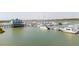 Picturesque aerial view of the marina, showcasing the docks and multiple boats, with a unique stilt house at 68 W 9Th St # B, Folly Beach, SC 29439