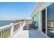 Enjoy the view from this balcony with lounge chairs and an adjacent door to the home's interior at 68 W 9Th St # B, Folly Beach, SC 29439