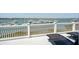 Partial view from the balcony of harbor featuring sleek lounge chairs and decorative white railing at 68 W 9Th St # B, Folly Beach, SC 29439