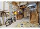 Functional basement space with stairs, shelving, and a patterned rug adding character to the space at 68 W 9Th St # B, Folly Beach, SC 29439