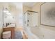 Bright bathroom features double sinks, soaking tub, glass enclosed shower, and tile floors at 68 W 9Th St # B, Folly Beach, SC 29439