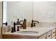 Close-up of bathroom vanity with double sinks, tile countertops, and dark bronze fixtures at 68 W 9Th St # B, Folly Beach, SC 29439