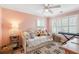 A cozy bedroom featuring a daybed with plush pillows, a ceiling fan, and plantation shutters at 68 W 9Th St # B, Folly Beach, SC 29439