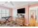 Bedroom with a chest of drawers, TV, area rug and access to other rooms at 68 W 9Th St # B, Folly Beach, SC 29439
