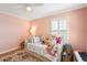 Unique bedroom design featuring daybed, whimsical pillows, and bright natural lighting at 68 W 9Th St # B, Folly Beach, SC 29439
