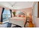 This relaxing bedroom with accent wall, ceiling fan, and balcony access is the perfect retreat at 68 W 9Th St # B, Folly Beach, SC 29439
