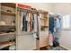 Spacious walk-in closet with custom shelving, hanging rods, drawers, and window for natural light at 68 W 9Th St # B, Folly Beach, SC 29439