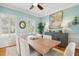 Well lit dining room showcases neutral colored walls, plantation shutters, hardwood floors, and stylish decor at 68 W 9Th St # B, Folly Beach, SC 29439