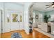 Elegant entryway featuring hardwood floors, white wainscoting, and views to the dining room at 68 W 9Th St # B, Folly Beach, SC 29439