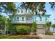Charming waterfront home featuring a classic raised foundation, lush landscaping, and a serene atmosphere at 68 W 9Th St # B, Folly Beach, SC 29439