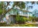 Charming waterfront home featuring a classic raised foundation, lush landscaping, and convenient side stairs at 68 W 9Th St # B, Folly Beach, SC 29439