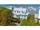 Charming waterfront home boasts delightful curb appeal with its coastal color scheme, dormer windows, and lush landscaping at 68 W 9Th St # B, Folly Beach, SC 29439