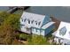 Charming light green house with dormer windows, a gray roof, and a covered porch at 68 W 9Th St # B, Folly Beach, SC 29439