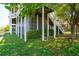 Coastal house foundation featuring pilings, vertical siding, lush greenery, and exterior stairs at 68 W 9Th St # B, Folly Beach, SC 29439