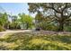 Wide view of the expansive front yard with mature trees and parking space at 68 W 9Th St # B, Folly Beach, SC 29439
