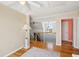 Bright hallway leading to an upstairs landing with views of the elegant staircase and a doorway at 68 W 9Th St # B, Folly Beach, SC 29439