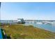 Harbor view featuring many boats docked near a building on a pier in this coastal community at 68 W 9Th St # B, Folly Beach, SC 29439