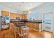 Well-lit kitchen boasting custom wood cabinets, stainless steel appliances, stylish backsplash, and an island with barstool seating at 68 W 9Th St # B, Folly Beach, SC 29439
