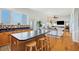 Open-concept kitchen featuring a center island with seating, wooden cabinets, and seamless access to the living area at 68 W 9Th St # B, Folly Beach, SC 29439