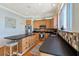 Well-lit kitchen features wooden cabinetry, stainless appliances, black counters, and a large island with stool at 68 W 9Th St # B, Folly Beach, SC 29439