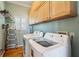 Laundry room with LG washer and dryer and natural wood cabinets for ample storage at 68 W 9Th St # B, Folly Beach, SC 29439