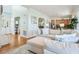 Spacious living room with hardwood floors, comfortable seating, and views into other rooms at 68 W 9Th St # B, Folly Beach, SC 29439