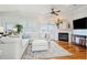 Bright living room featuring a fireplace, comfortable seating, and access to a balcony at 68 W 9Th St # B, Folly Beach, SC 29439