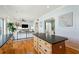 Open concept living space with kitchen island, bright living room with hardwood floors, and ample seating at 68 W 9Th St # B, Folly Beach, SC 29439