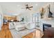 Open-concept living space with kitchen view, fireplace, balcony access and modern furnishings at 68 W 9Th St # B, Folly Beach, SC 29439